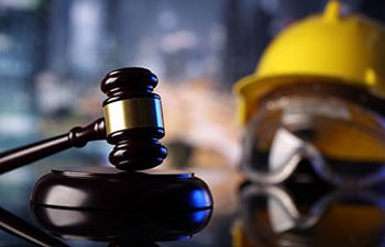 judge's gavel and a constructor helmet