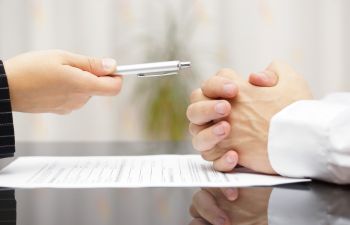 Signing a Contract at Desk