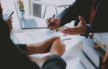 Businessmen seeking legal assistance during a mitting at attorney's office.