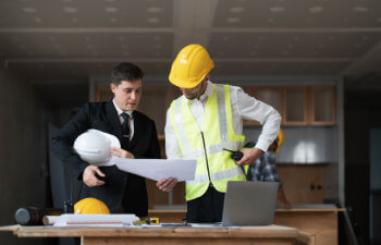 Diverse Team of Specialists Use Laptop on Construction Site Real Estate Building Project