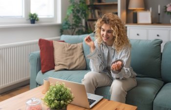 Young woman talking on video call with her psychotherapist doctor after online therapy sessions, happy that she is well and mentally health now after telemedicine conversations. Thank you for help